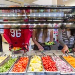 Students and Swoop getting food from the PHC dining room